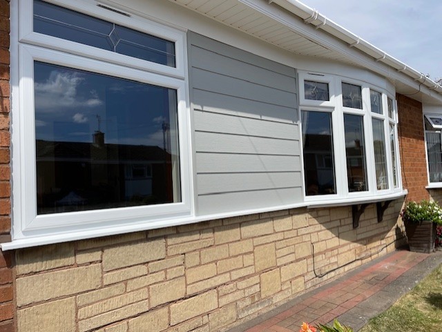 WHITE UPVC WINDOWS WITH BESPOKE FANLIGHT & AGATE CLADDING